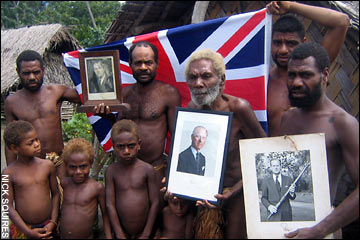 Chief Jack showing three portraits given the tribe by Prince Philip